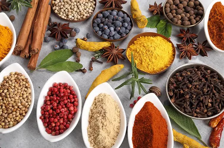 Bowls of whole spices, seeds and dried fruit